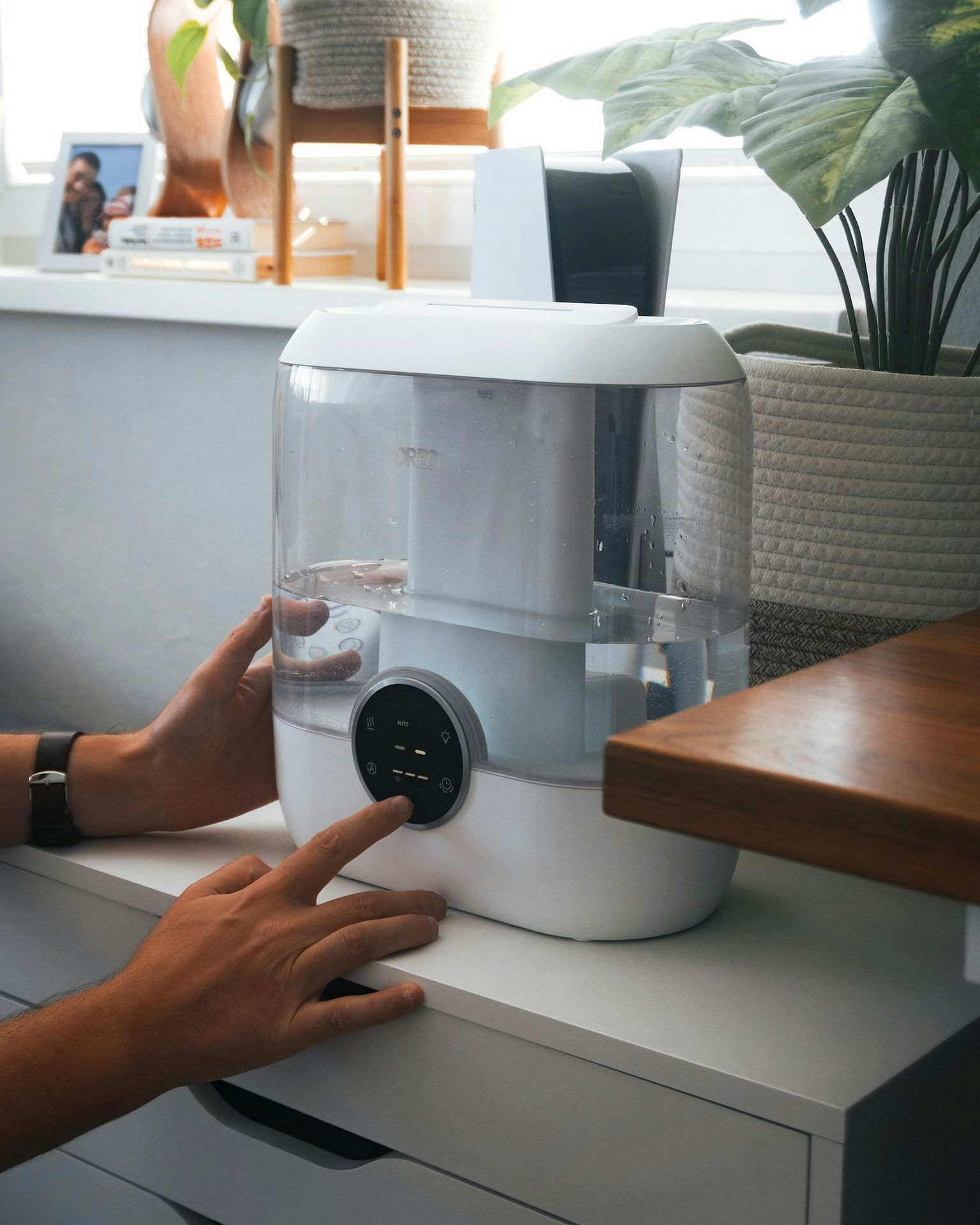 A person is holding a water dispenser on a counter